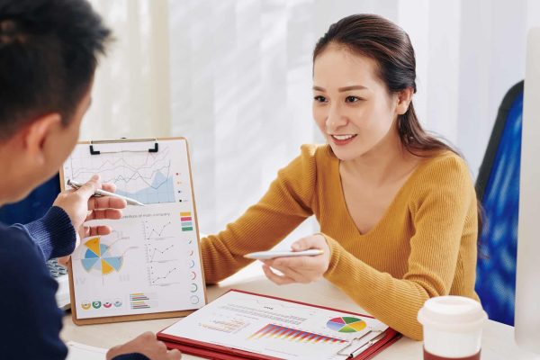 businesswoman-showing-document-to-colleague.jpg